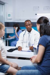 doctor-discusses-with-mother-about-child_482257-83482